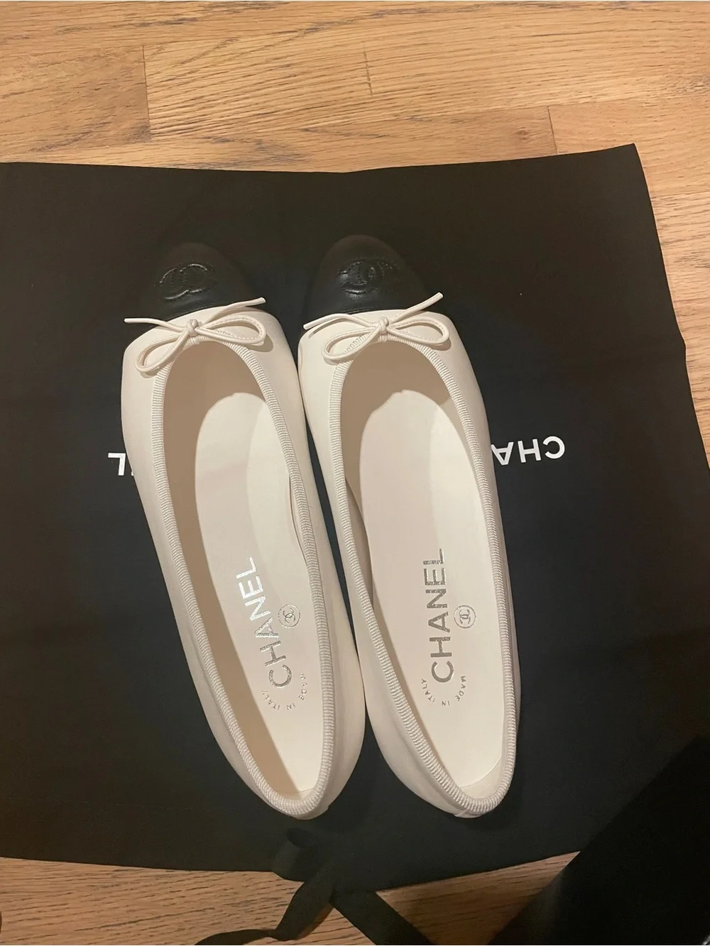 CHANEL Two-Tone Leather Cap-Toe Ballet Flats in Cream and Black